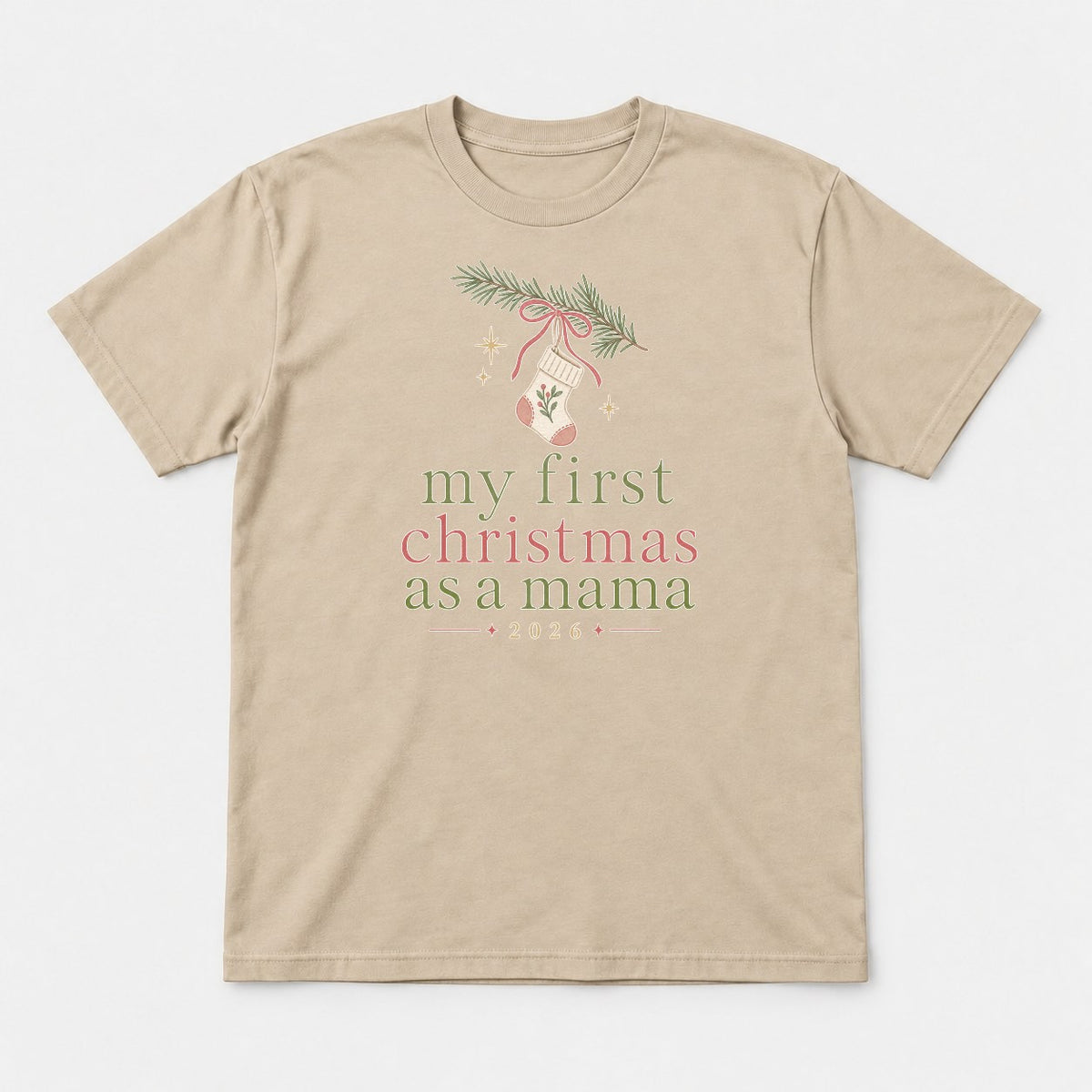 My First Christmas As A Mama 2026 Stocking Graphic T-Shirt & Sweatshirt - Tshirt Sand Front